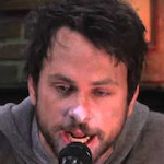 A headshot of Charlie Kelly from It's Always Sunny in Philidelphia, his face covered in silver from huffing spray paint.